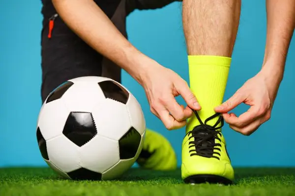 Why did the footballer hold his boot to his ear?