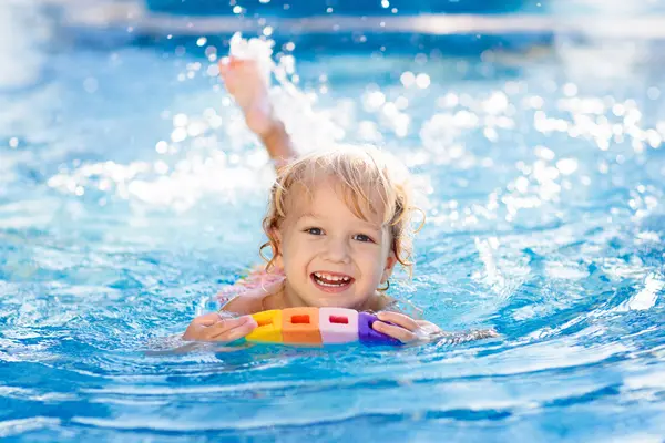 What does a toddler wear while swimming on summer vacation?