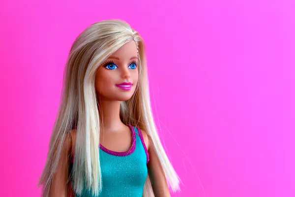 Which famous singer loves to play with Barbie™ dolls?